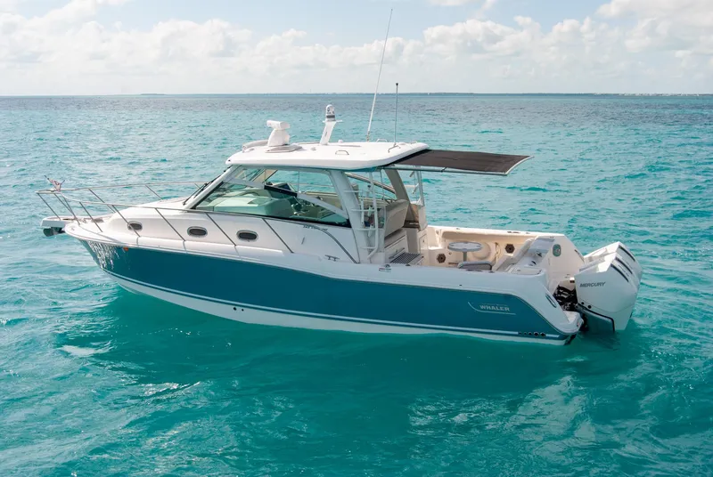 Slide: The Image of 2021 Boston Whaler 345 Conquest boat on clear blue ocean water. - 48