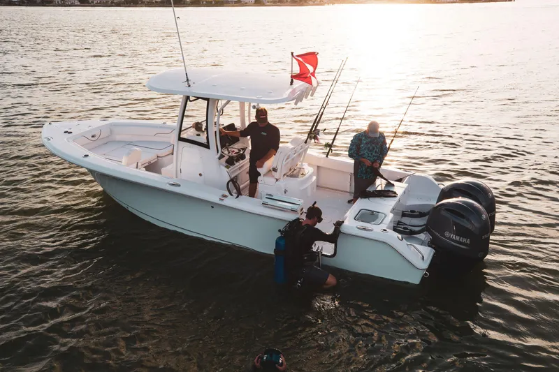 Slide: The Image of 2025 Sea Hunt Gamefish 25 boat on water with fishing gear and divers. - 10