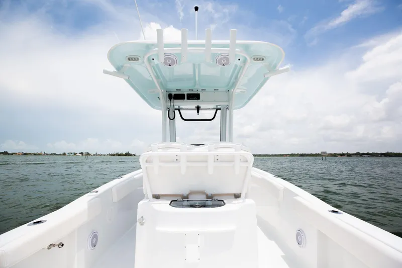 Slide: The Image of 2025 Sea Hunt Gamefish 25 boat on open water under clear sky. - 12