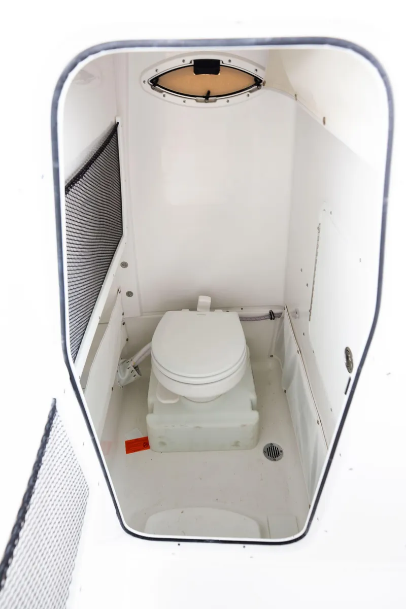 Slide: The Image of 2025 Sea Hunt Gamefish 25 boat interior with compact marine toilet. - 13