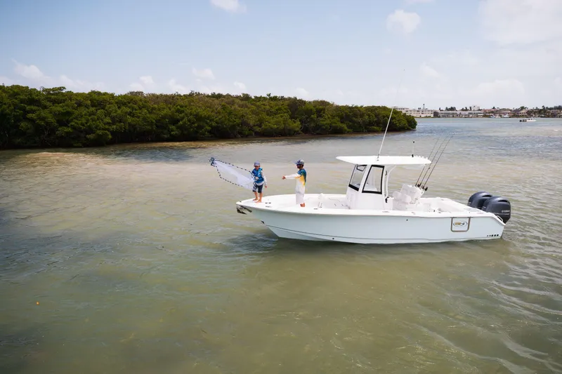 Slide: The Image of 2025 Sea Hunt Gamefish 25 boat on calm waters, two people fishing. - 4
