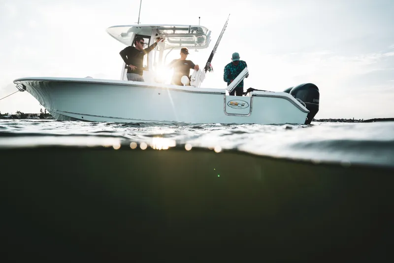 Slide: The Image of 2025 Sea Hunt Gamefish 25 boat on water with three people fishing. - 5