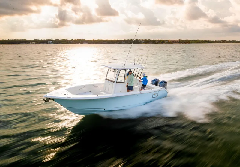 Slide: The Image of 2025 Sea Hunt Gamefish 25 speeding on open water at sunset. - 7