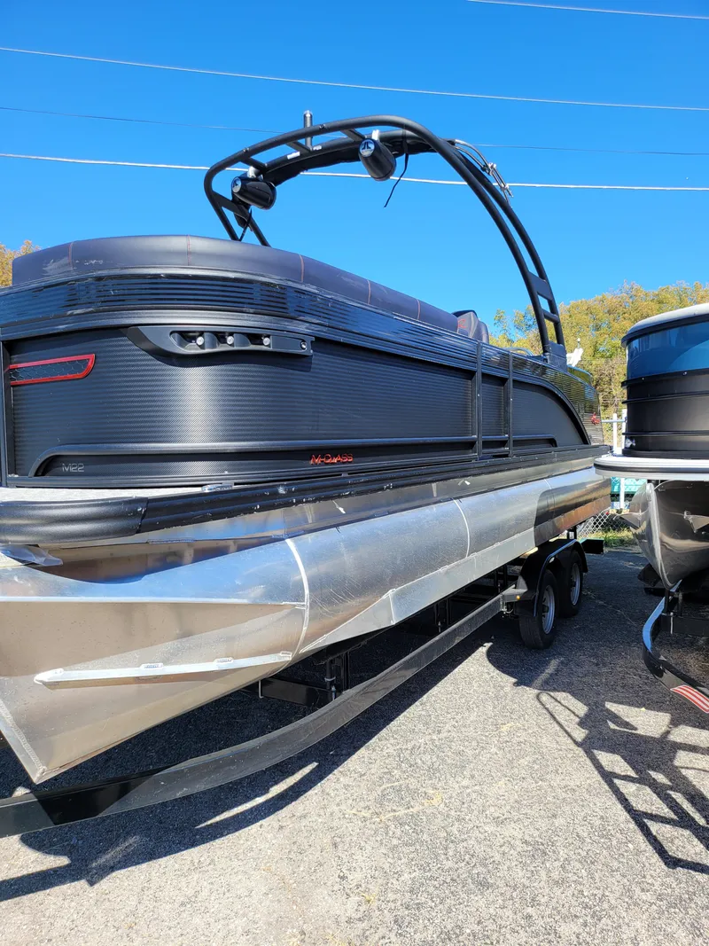 Slide: The Image of 2025 Quest M-22RLS LIMITED pontoon boat with sleek black design and modern features. - 1