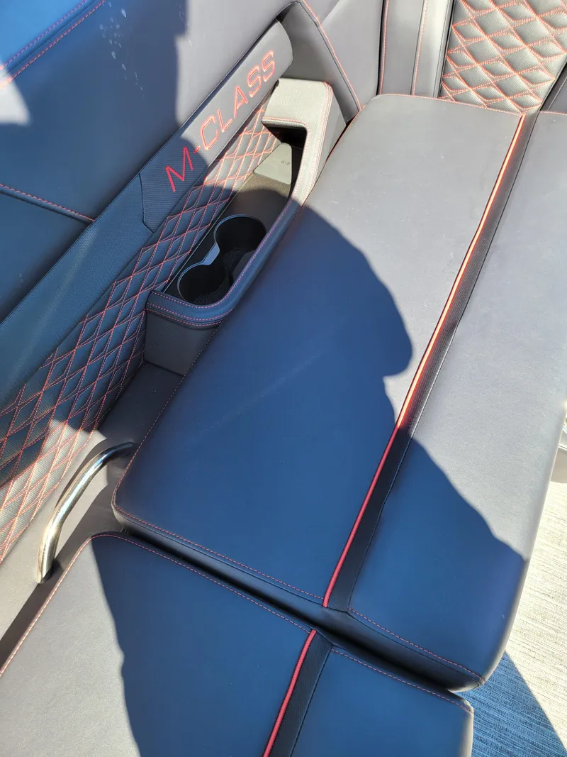 Slide: The Image of 2025 Quest M-22RLS LIMITED interior with black leather seats and red stitching. - 14