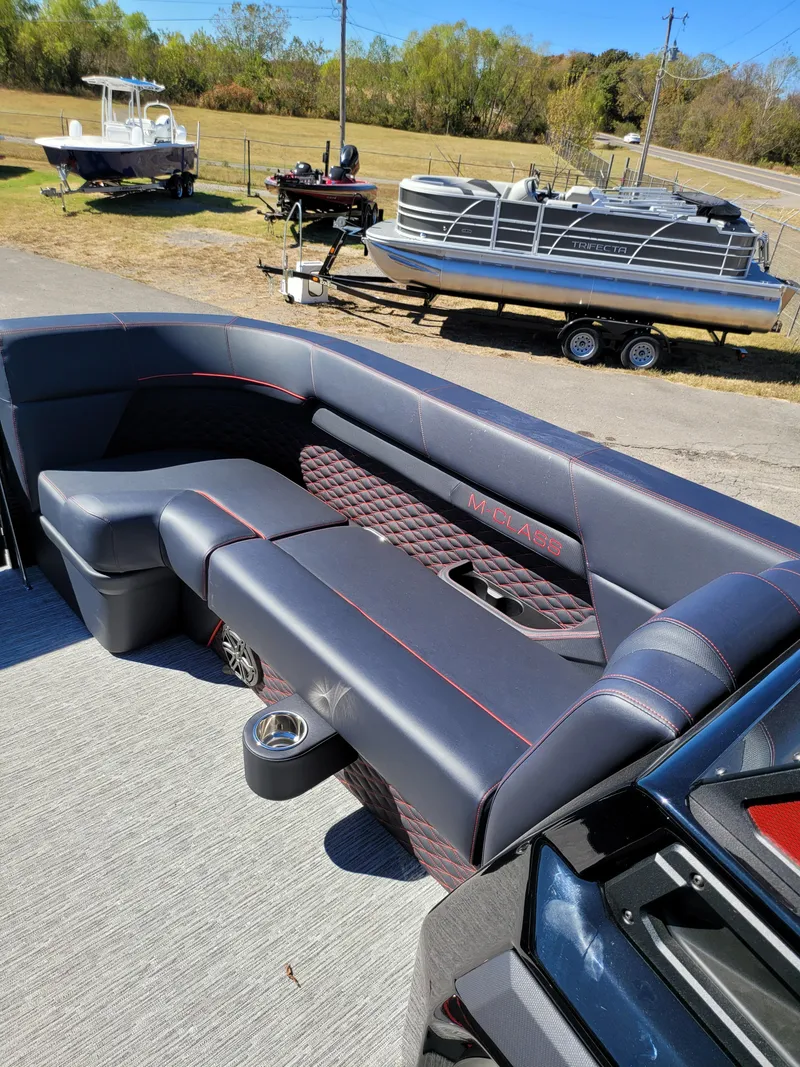 Slide: The Image of 2025 Quest M-22RLS LIMITED boat interior with luxurious seating and cup holders. - 16