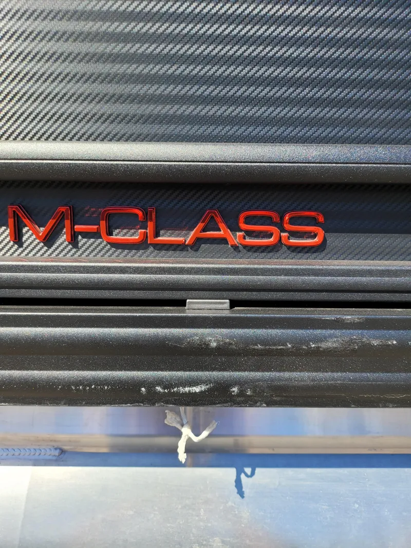 Slide: The Image of 2025 Quest M-22RLS LIMITED M-Class logo on carbon fiber background. - 2