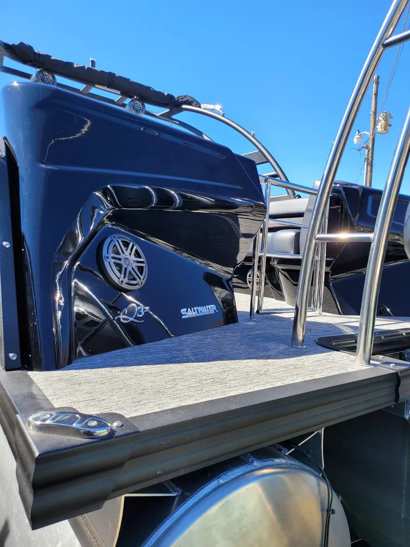 Slide: The Image of 2025 Quest M-22RLS LIMITED boat, sleek black design, stainless steel railings, sunny day. - 9