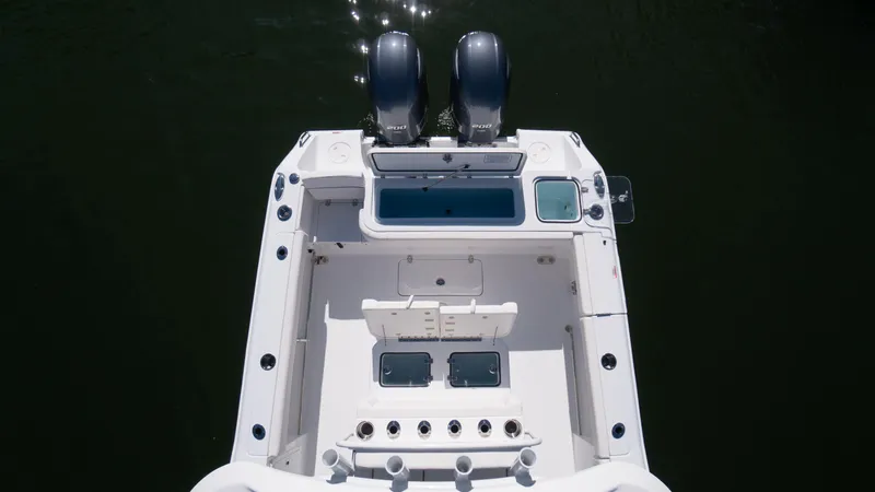 Slide: The Image of 2025 Sea Hunt Gamefish 27 Coffin Box boat, aerial view of deck and twin engines. - 10
