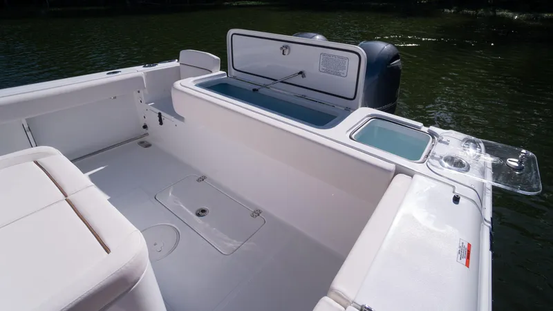 Slide: The Image of 2025 Sea Hunt Gamefish 27 Coffin Box boat interior with open storage compartment. - 11