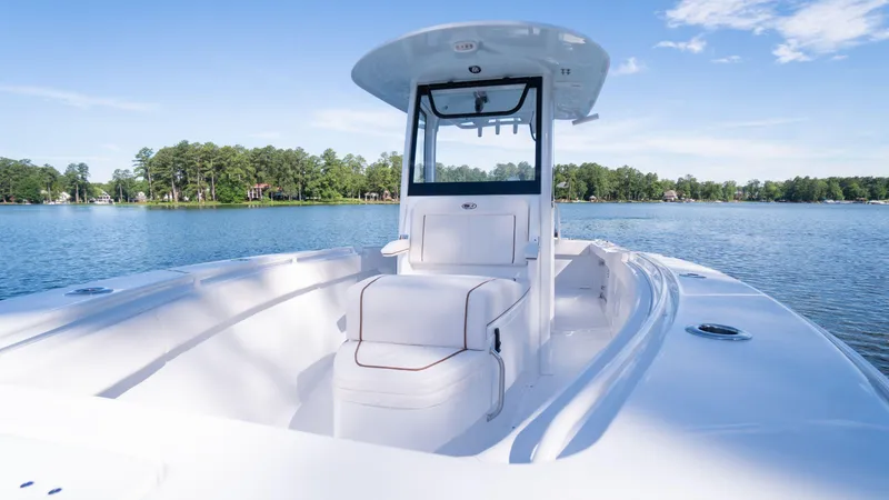 Slide: The Image of 2025 Sea Hunt Gamefish 27 Coffin Box on serene lake. - 19