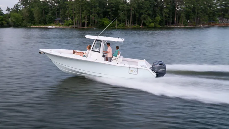 Slide: The Image of 2025 Sea Hunt Gamefish 27 Coffin Box cruising on a lake with passengers. - 23