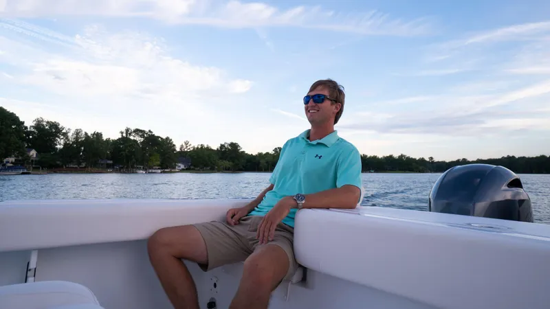 Slide: The Image of Man relaxing on a 2025 Sea Hunt Gamefish 27 Coffin Box boat, enjoying a sunny day. - 28