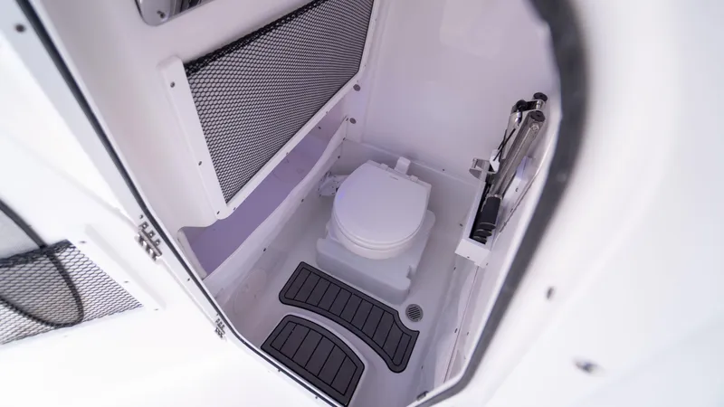 Slide: The Image of 2025 Sea Hunt Gamefish 27 Coffin Box boat interior with compact marine toilet. - 33