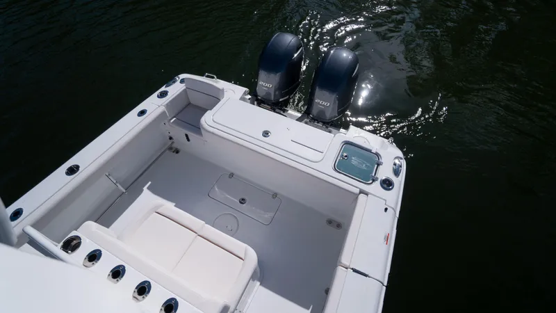 Slide: The Image of 2025 Sea Hunt Gamefish 27 Coffin Box boat with dual engines on water. - 6