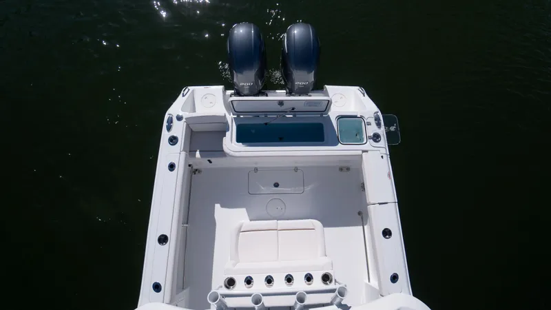 Slide: The Image of 2025 Sea Hunt Gamefish 27 Coffin Box boat, aerial view of deck and twin engines. - 8