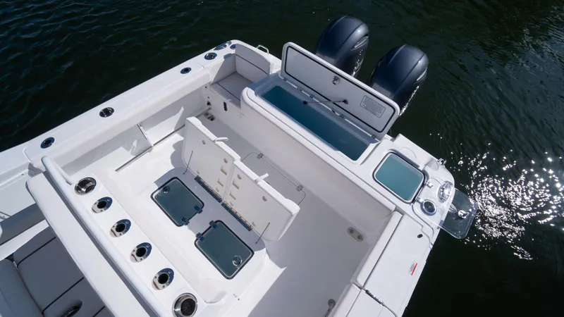 Slide: The Image of 2025 Sea Hunt Gamefish 27 Coffin Box boat interior with dual engines and storage compartments. - 9
