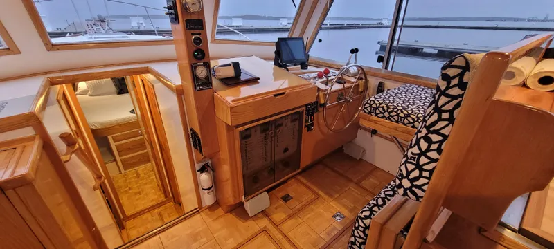 Slide: The Image of 1989 Duffy Wilbur 42 Flybridge Cruiser interior with helm, seating, and wood finish. - 10