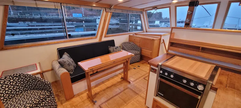 Slide: The Image of Interior of 1989 Duffy Wilbur 42 Flybridge Cruiser with seating, table, and kitchen area. - 21