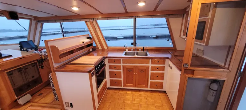 Slide: The Image of Interior of 1989 Duffy Wilbur 42 Flybridge Cruiser with wooden cabinetry and ocean view. - 22