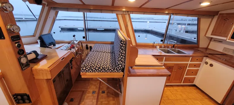 Slide: The Image of 1989 Duffy Wilbur 42 Flybridge Cruiser interior with helm, seating, and kitchen area. - 25