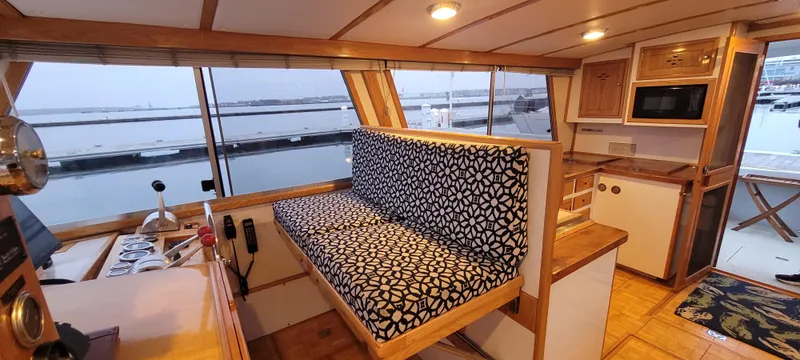 Slide: The Image of Interior of 1989 Duffy Wilbur 42 Flybridge Cruiser with patterned seating and wooden cabinetry. - 26