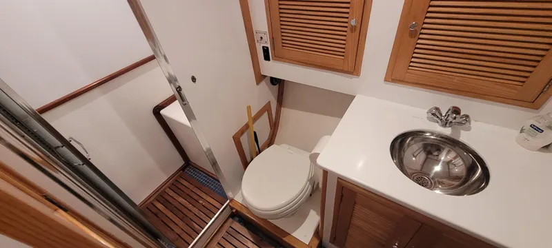 Slide: The Image of 1989 Duffy Wilbur 42 Flybridge Cruiser bathroom with wooden accents and compact design. - 31