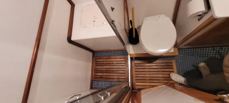 Slide: The Image of Bathroom interior of 1989 Duffy Wilbur 42 Flybridge Cruiser with wooden flooring and toilet. - 32