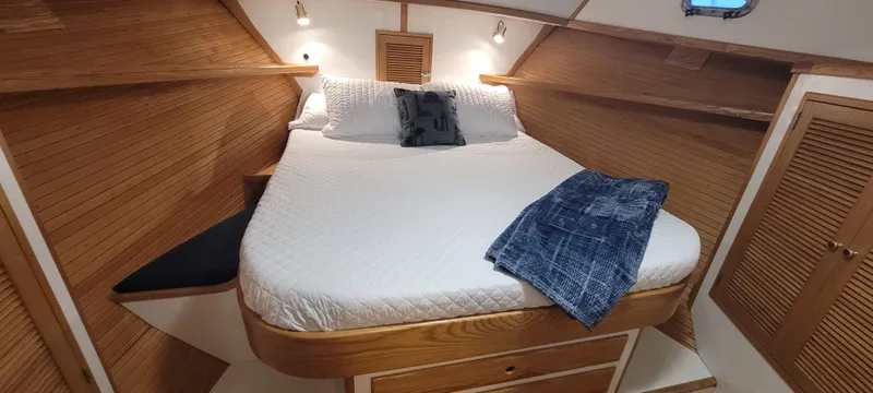 Slide: The Image of Cozy cabin interior of 1989 Duffy Wilbur 42 Flybridge Cruiser with wooden accents and comfortable bedding. - 34