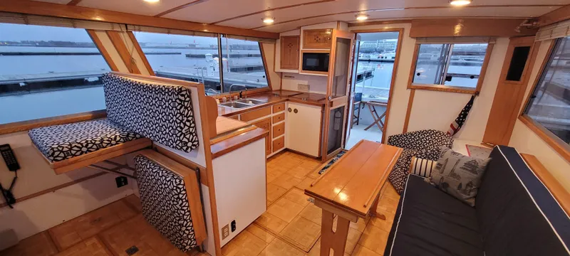 Slide: The Image of Interior of 1989 Duffy Wilbur 42 Flybridge Cruiser with seating, kitchenette, and harbor view. - 6