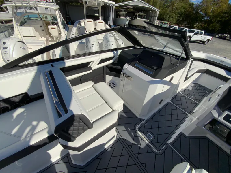 Slide: The Image of 2025 Cobalt R6 Outboard boat interior with modern seating and dashboard design. - 14