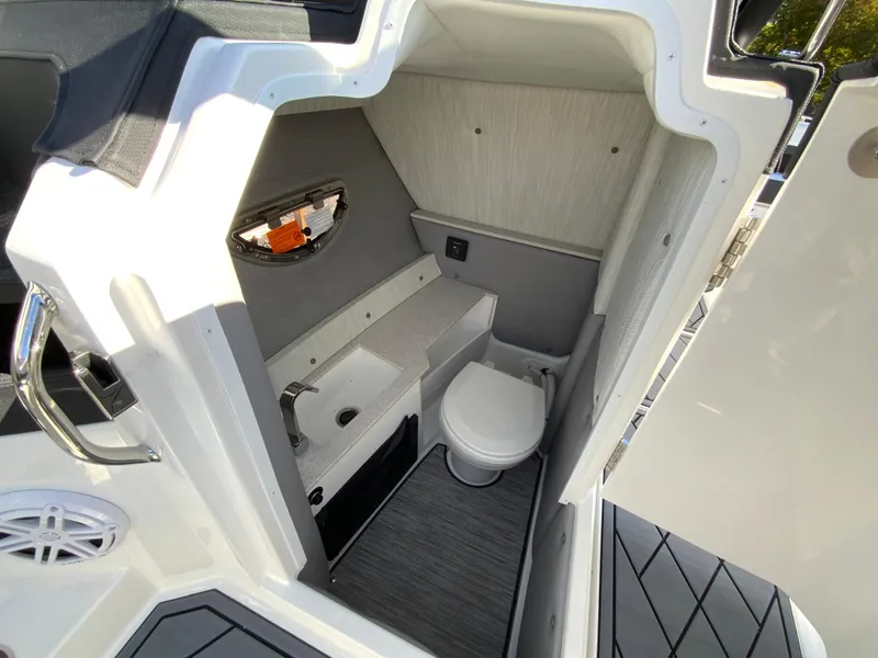 Slide: The Image of 2025 Cobalt R6 Outboard boat interior with compact bathroom and modern amenities. - 22