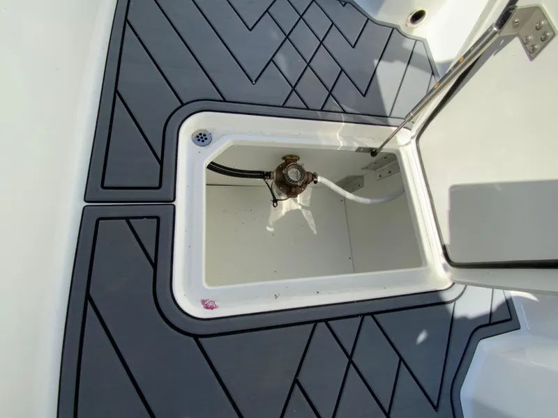 Slide: The Image of 2025 Cobalt R6 Outboard boat storage compartment with open hatch. - 30
