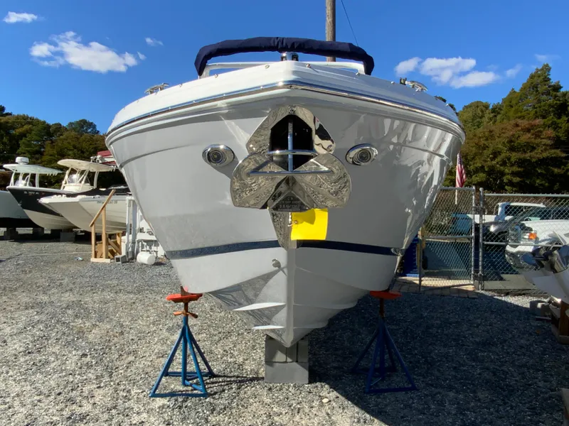 Slide: The Image of 2025 Cobalt R6 Outboard boat on stands in a marina, clear blue sky. - 4