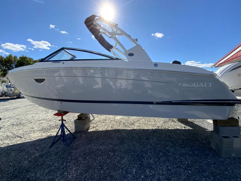 Slide: The Image of 2025 Cobalt R6 Outboard boat displayed outdoors under bright sunlight. - 6