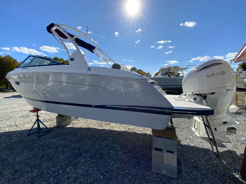 Slide: The Image of 2025 Cobalt R6 Outboard boat displayed outdoors under a clear blue sky. - 7