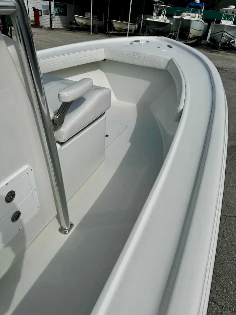 Slide: The Image of 2025 Pair Customs 27 Center Console boat, sleek white interior, docked at marina. - 19