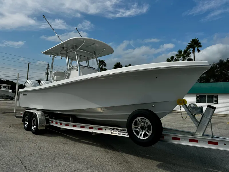 Slide: The Image of 2025 Pair Customs 27 Center Console boat on trailer under blue sky. - 3