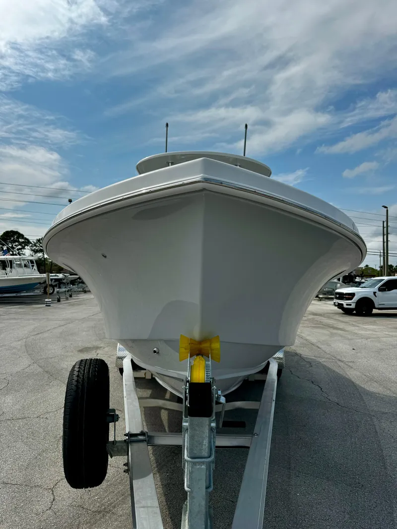 Slide: The Image of 2025 Pair Customs 27 Center Console boat on trailer under cloudy sky. - 4