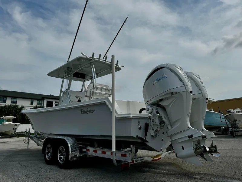 Slide: The Image of 2025 Pair Customs 27 Center Console boat on trailer, dual outboard engines. - 7