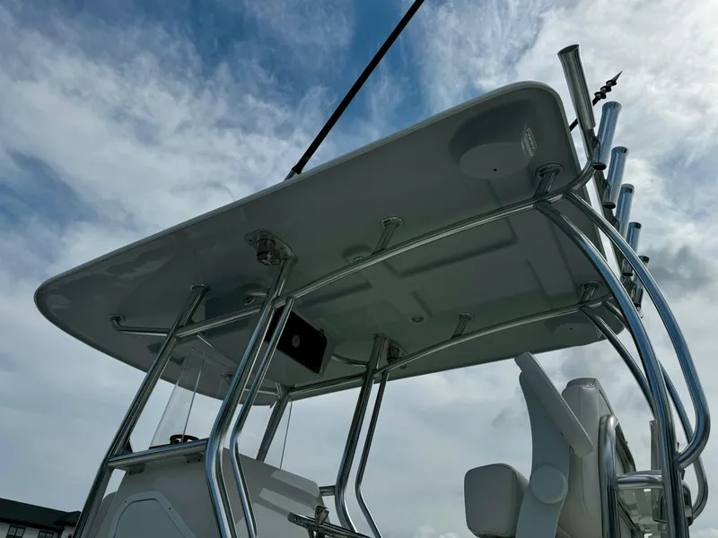 Slide: The Image of 2025 Pair Customs 27 Center Console boat with T-top against cloudy sky. - 9