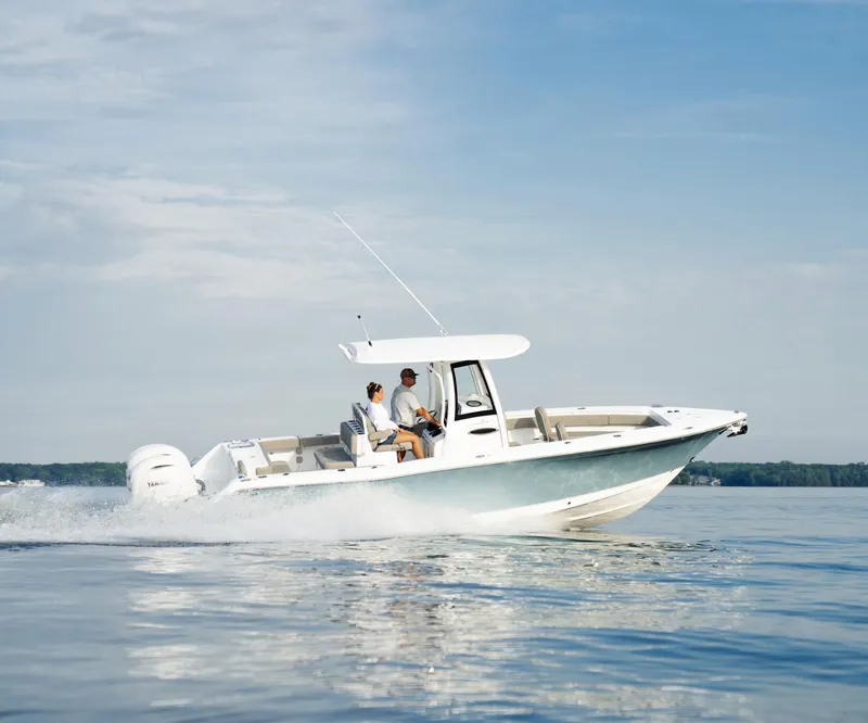 Slide: The Image of 2025 Sea Hunt Gamefish 27 boat cruising on calm water under a clear sky. - 0