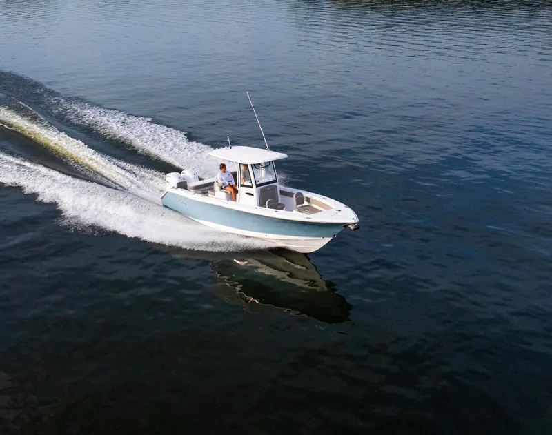 Slide: The Image of 2025 Sea Hunt Gamefish 27 cruising on calm water, showcasing sleek design and forward seating. - 14