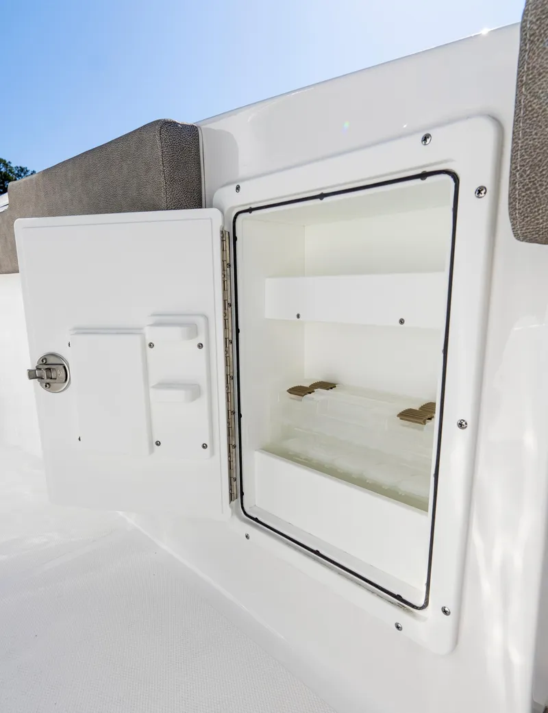 Slide: The Image of 2025 Sea Hunt Gamefish 27 storage compartment with open door, showcasing interior space. - 15