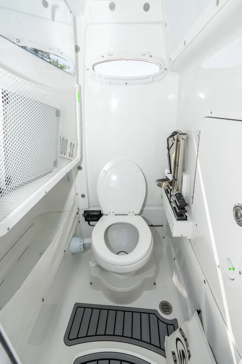 Slide: The Image of 2025 Sea Hunt Gamefish 27 boat interior bathroom with modern white fixtures. - 17