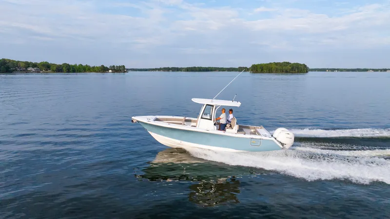 Slide: The Image of 2025 Sea Hunt Gamefish 27 cruising on a serene lake. - 2