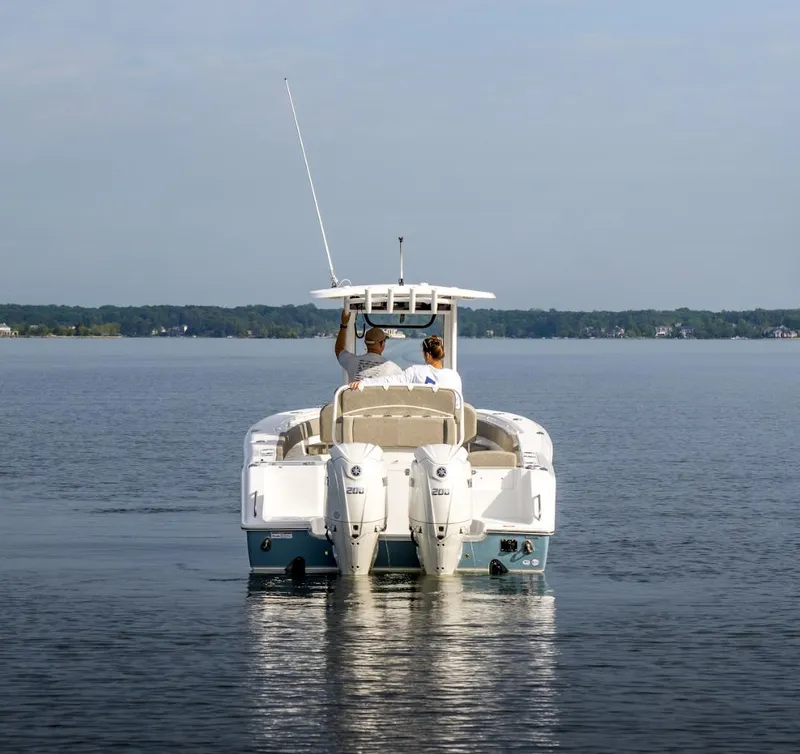 Slide: The Image of 2025 Sea Hunt Gamefish 27 boat on calm water, rear view. - 23