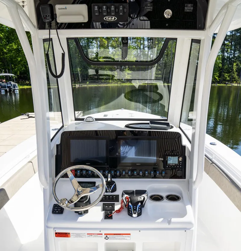 Slide: The Image of 2025 Sea Hunt Gamefish 27 boat dashboard with advanced navigation systems. - 24