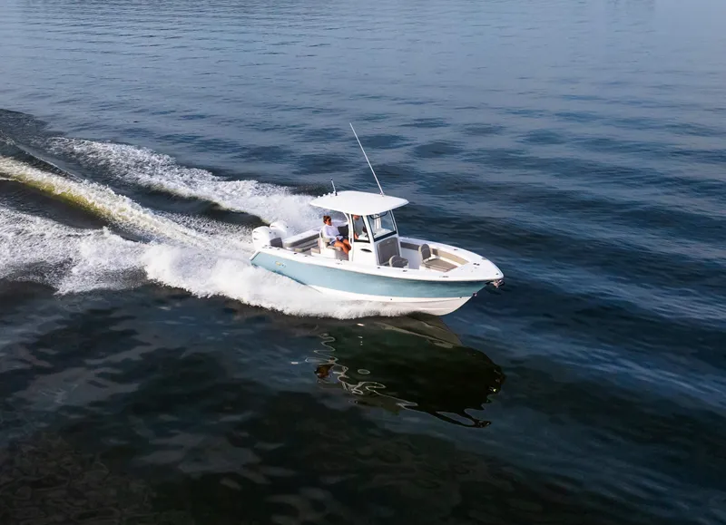 Slide: The Image of 2025 Sea Hunt Gamefish 27 boat cruising on open water, showcasing forward seating design. - 3