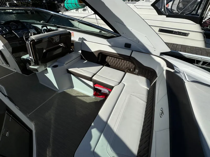 Slide: The Image of 2018 Monterey 328 Super Sport boat interior with luxurious seating and modern dashboard. - 13